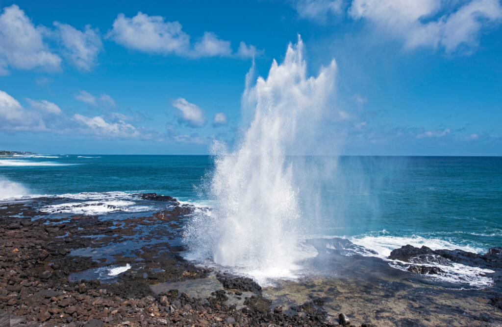 The Spouting Horn on the Island of Kauai is a must-see. Buy some souvenirs from the pop-up shops nearby. 